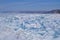 Large iridescent crystals white blue ice floes with cracks glow in the light of the sun, lake baikal in snow