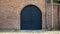 large iron door of a medieval defensive brick tower