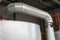 Large iron heat exchanger, tank, reactor, distillation column in thermal insulation of fiberglass and mineral wool of galvanized