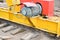 Large iron metal yellow supports on rails with wheels with an induction motor of a large construction stationary industrial