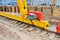 Large iron metal yellow supports on rails with wheels with an induction motor of a large construction stationary industrial