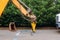 Large jackhammer crushing asphalt paving during road construction works