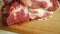 A large, juicy piece of meat is placed on a wooden board. Start cooking.