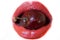 A large juicy red cherry berry, covered with drops of water, in the girlâ€™s mouth
