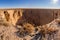 Large karst dip in the ground in sunny desert