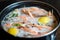Large king prawns are cooked and boiled in saucepan. Cooking with spices and lemon