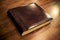 Large leather-bound book on wooden background