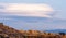 Large lenticular clouds over the roofs of residential houses in a housing estate