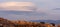 Large lenticular clouds over the roofs of residential houses in a housing estate