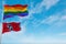 large lgbt flag and flag of Tennessee state, USA waving in the wind at cloudy sky. Freedom and love concept. Pride month. activism