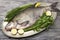 A large live bream river fish fish lying on a on on an iron tray with a knife and slices of lemon and with salt dill