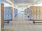 Large locker room with lockers and benches on the floor tiled. The clock hangs on the wall