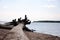 A large log of a felled tree lies on a sandy beach, half in the water