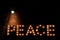 Large luminous inscription "Peace" from light bulbs, in the dark