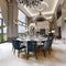 Large luxurious dining table in the large living room with high ceilings in a modern classic style with blue chairs and a white