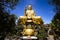 A large, majestic and beautiful figure of a seated golden buddha