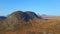 Large massive mountain in autumn colors, above the tree line and mountain plateau.