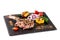 Large meat steak on the bone, grilled, served with grilled vegetables, corn, red onion, sweet peppers, potatoes. Modern serving