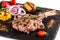 Large meat steak on the bone, grilled, served with grilled vegetables, corn, red onion, sweet peppers, potatoes. Modern serving