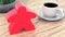 A large meeple next to a cup of coffee. 3d render