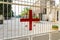 A large metal cross of red color is attached to the gate to the catholic Christian Transfiguration Church located on Mount Tavor