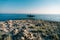 A large metal green lighthouse on a rock in the sea, near Cape Punta Planka in Croatia.