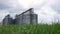 Large metal silos, modern grain elevator with a cleaning line and plant for processing, drying, cleaning and storing
