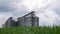 Large metal silos, modern grain elevator with a cleaning line and plant for processing, drying, cleaning and storing