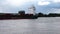 Large metal transport ship bulk carrier. A barge sailing with a cargo of containers from the port along the river. Sea transportat