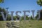 Large metallic letters with the name of city of Viseu, located in urban park of Viseu, background with historical center