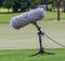 A large microphone boom with stand for TV or Radio situated.