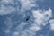 Large military helicopter hovers in sky. A camouflaged helicopter flies at high speed.