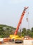 The large mobile crane with the long boom is ready to lift the metal frame