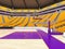 Large modern basketball arena with yellow seats