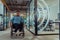 In a large modern corporation, a determined businessman in a wheelchair navigates through a hallway, embodying