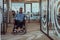 In a large modern corporation, a determined businessman in a wheelchair navigates through a hallway, embodying