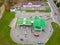 Large modern gas station top view. Cars drive up to the gas station for refueling with gasoline or gas. The drone flies over the