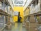 Large modern warehouse with forklifts, shelves with pallets, boxes, containers and goods