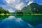 Large mountain with blue sky and reflection from the water.