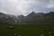 Large mountains covered with snow and dramtic clouds. Photo about mountains and lakes .