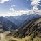 Large mountains with green glades into which clouds crash