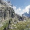 Large mountains with green glades into which clouds crash