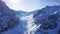 Large mountains and rocks covered with snow. Long gorge. The dam is covered with snow.