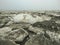 Large muddy ice floes melting in the arctic tundra on the coast of the Barents Sea. Varandey