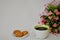 A large mug of black coffee, oatmeal cookies with cereals and a bouquet of Alstroemeria on a white background.