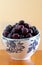 Large mug full of cherries on neutral background