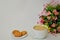 A large mug of white coffee, oatmeal cookies with cereals and a bouquet of Alstroemeria on a white background.