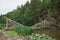 Large natural stepping stones across a flowing stream river lake canal peaceful still serene relaxing outdoors walk hike