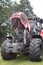 Large new red tractor with bonnet up showing engine in field