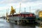 A large non propelled cargo barge at the port berth